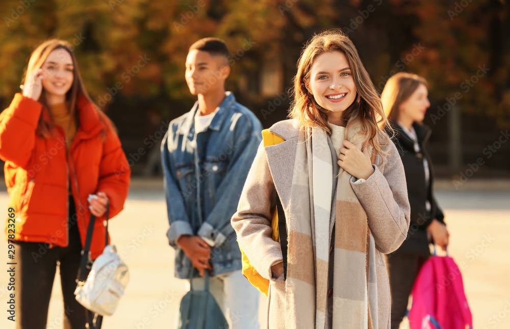 Teenage girl and her friends outdoors Teenage girl and her friends outdoors