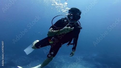 Wallpaper Mural SCUBA diver check hand in clear deep sea water Torontodigital.ca