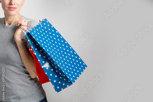 Beautiful shopping woman with shopping bags isolated over white background, copy space © Leart