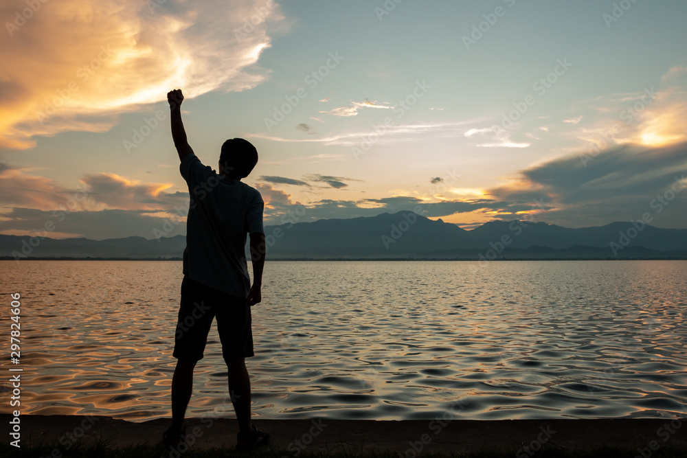 Fototapeta premium silhouette of man over sky and sun light background,business, success, leadership, achievement and people concept