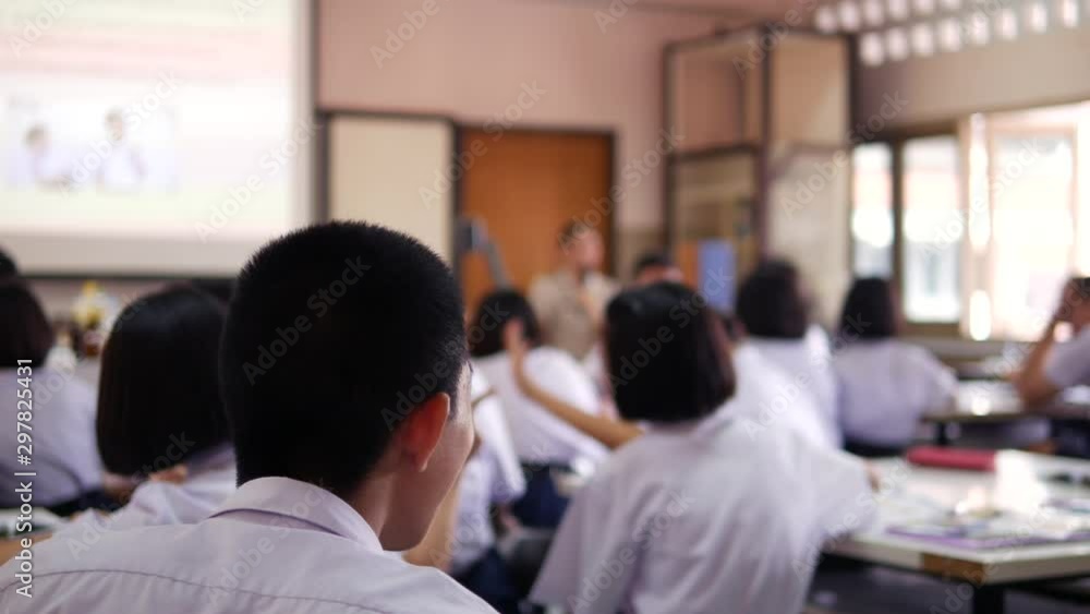 The Asian high school students in white uniform are studying in classroom. The Asian high school students in white uniform are studying in classroom.