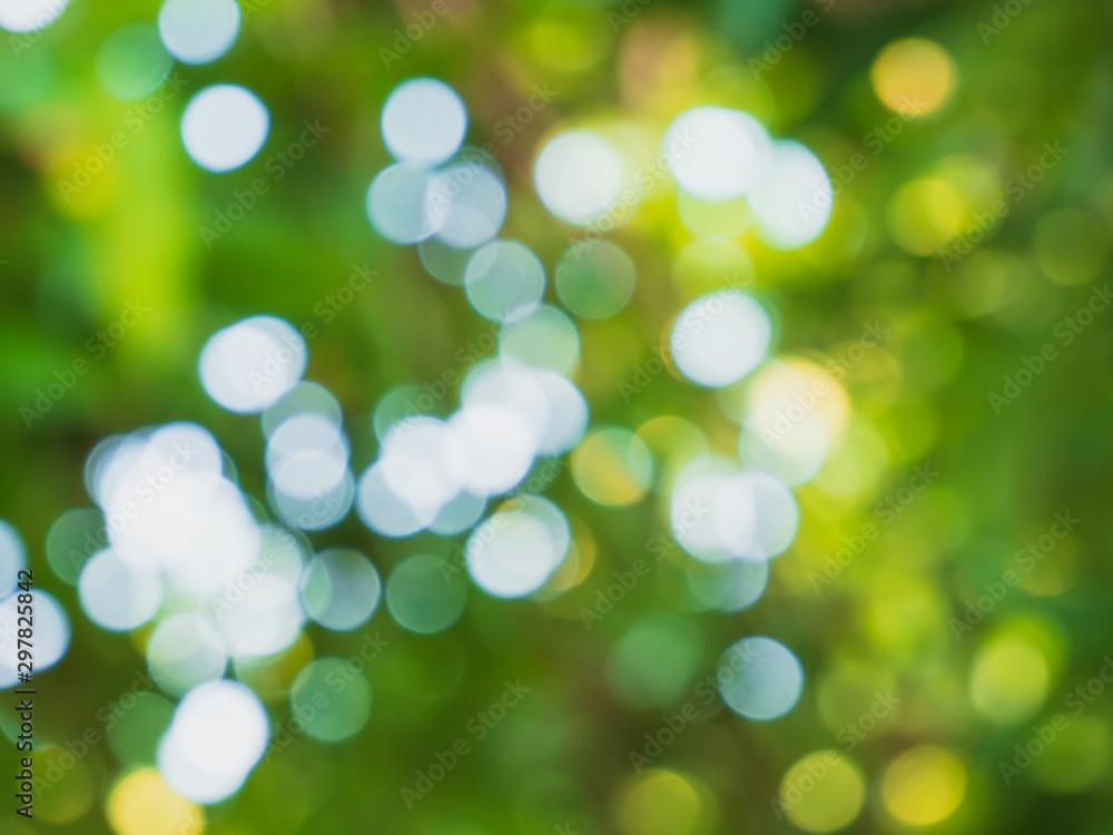 Obraz premium Bright green blurred bokeh background.