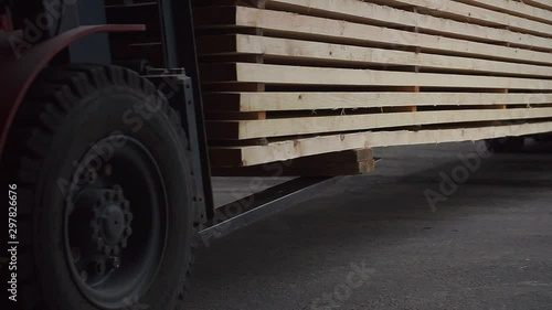 forklift loaders carry boards at plant closeup slow motion