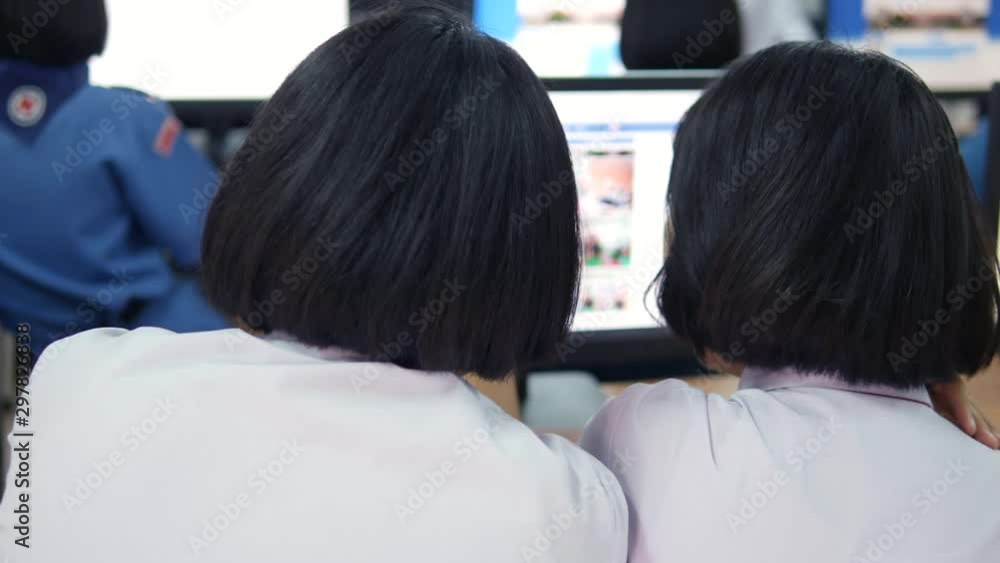 Female Asian high school students are searching knowledge on internet in the computer room. Female Asian high school students are searching knowledge on internet in the computer room.