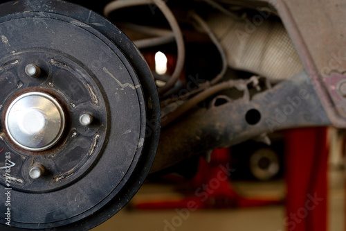 closeup repair disc brakes of car with soft-focus and over light in the background