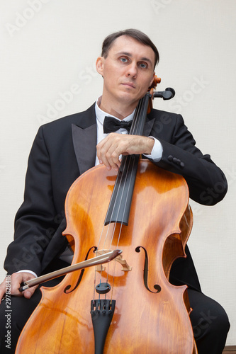 Musicians of the symphony orchestra. Cellist in concert costume.