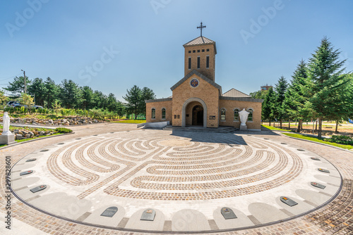 Catholic church and place with flags of countries involved in Korean war on the ground at Camp Bonifas in South Korea photo