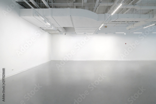 White walls and grey cement floors in the interior space