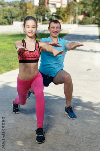 Girl doing exercises with father