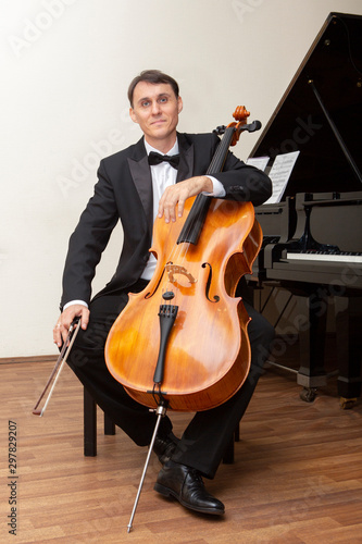 Musicians of the symphony orchestra. Cellist in concert costume.
