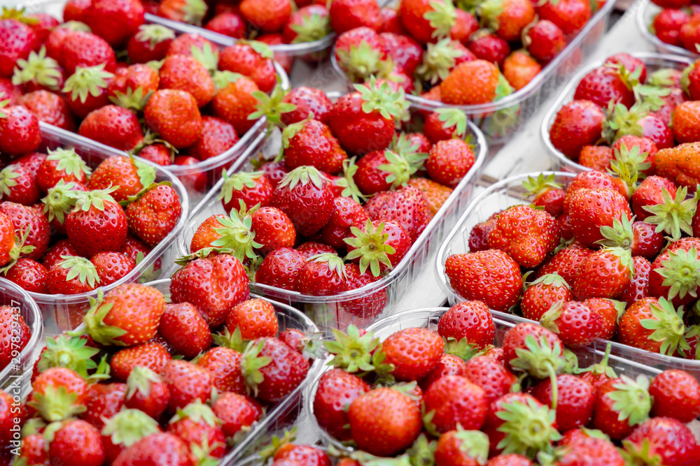 Baskets of juicy sweet red strawberries at the farmers market Baskets of juicy sweet red strawberries at the farmers market