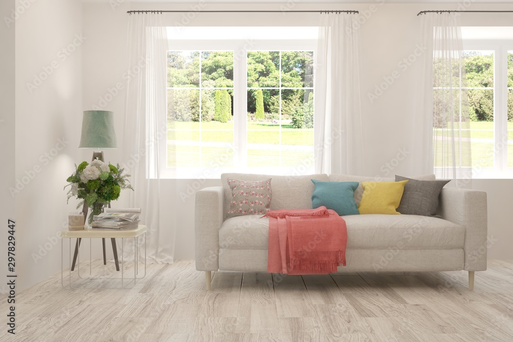 Fototapeta premium Stylish room in white color with sofa and summer landscape in window. Scandinavian interior design. 3D illustration