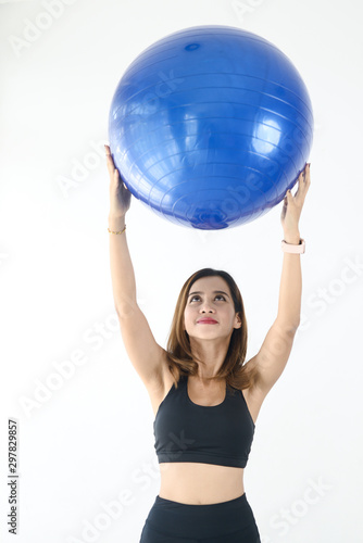 Asian sport woman holding blue ball pilates, lifestyle concept.