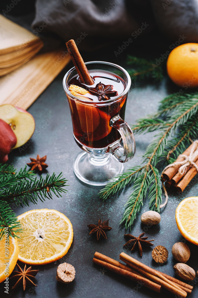 Christmas mulled wine or gluhwein with apple and orange slices in glass. Traditional drink on winter holiday Christmas mulled wine or gluhwein with apple and orange slices in glass. Traditional drink on winter holiday