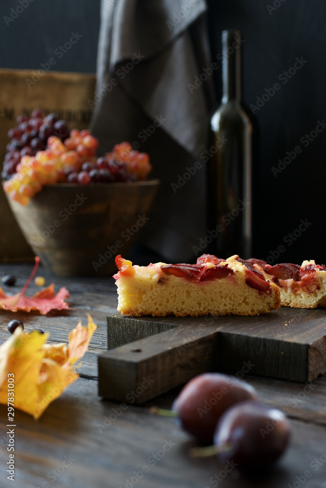 Slice of plum cake on a cutting board. Autumn still life