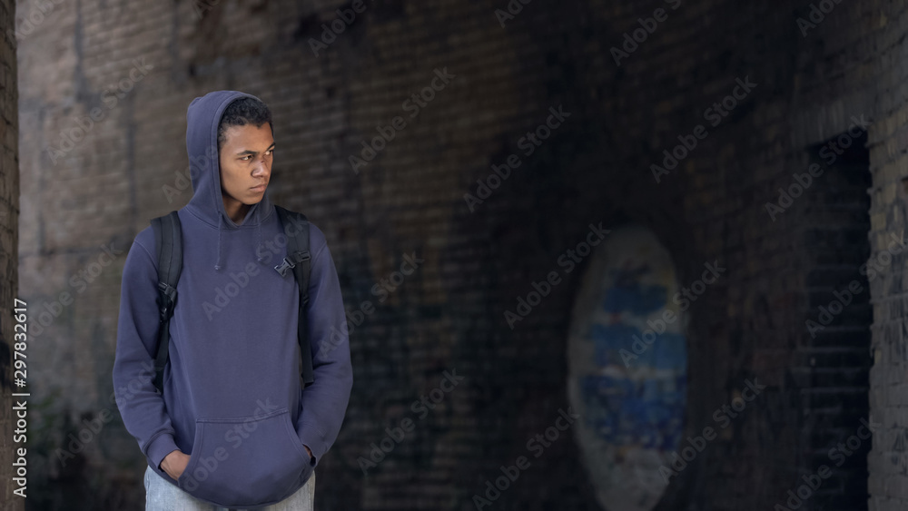 Sad black teenager walking alone abandoned building, puberty loneliness, problem Sad black teenager walking alone abandoned building, puberty loneliness, problem