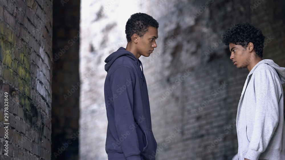 Two afro-american teenagers looking at each other, confrontation concept Two afro-american teenagers looking at each other, confrontation concept