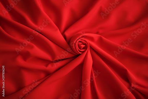 Red batiste made of cotton. sample of red soft fabric with pleats. Top view