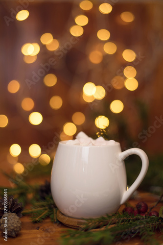 Cacao drink in a white cup with marshmallow on the background of bokeh lights, Hot Christmas drink