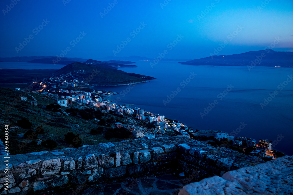 Early night landscape from Lekuresi Castle, Saranda, Albania with Adriatic Sea coast view, clear spring sky with haze, Kerkira island in Greece in the background