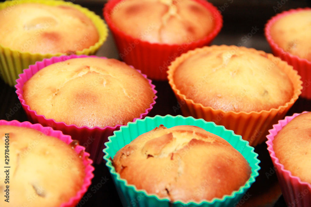 baked biscuit yellow edible cupcakes in multi-colored a silicone forms baked biscuit yellow edible cupcakes in multi-colored a silicone forms