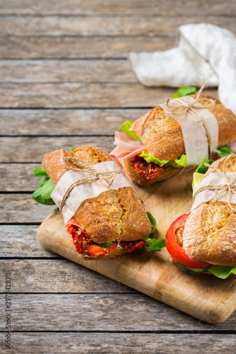 Fresh bread sandwich with ham, lettuce and tomato