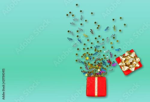 Red gift box with various party confetti