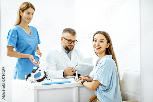 Portrait of a young patient at an appointment with otolaryngologists  sitting during the consultation in the bright ENT office interior