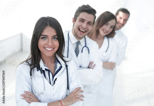 female doctor with group of happy successful colleagues © ASDF