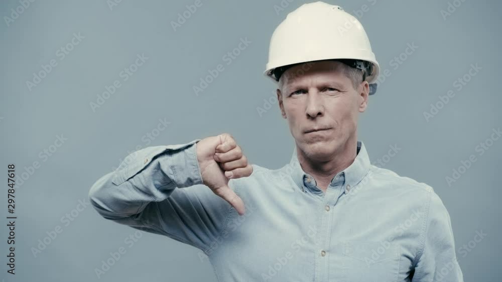 smiling architect in helmet showing thumb up smiling architect in helmet showing thumb up