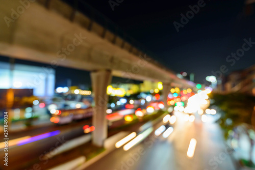 Blur of Pole of sky train with blur light of moving of traffic car 