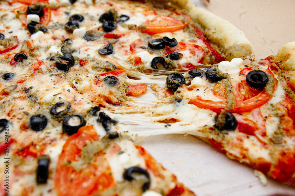 vegetarian pizza with olives, tomatoes and cheese.
