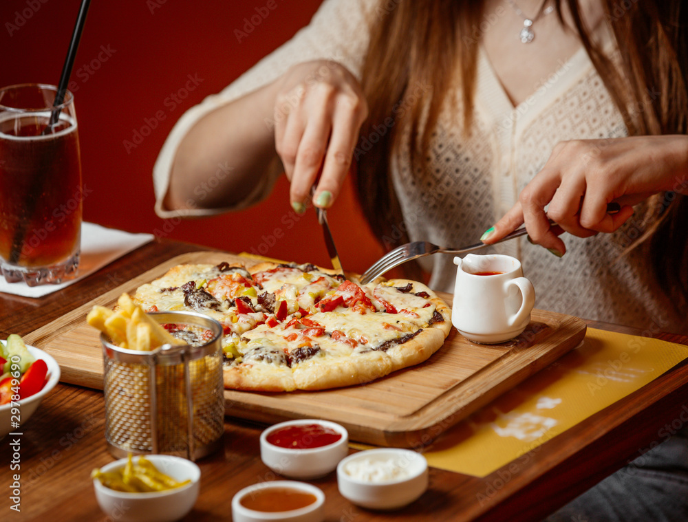 meat pizza with cheese and vegetables on wooden board