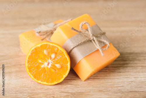 Orange soap wrapping with paper and ribbon, hamemade soap	 photo