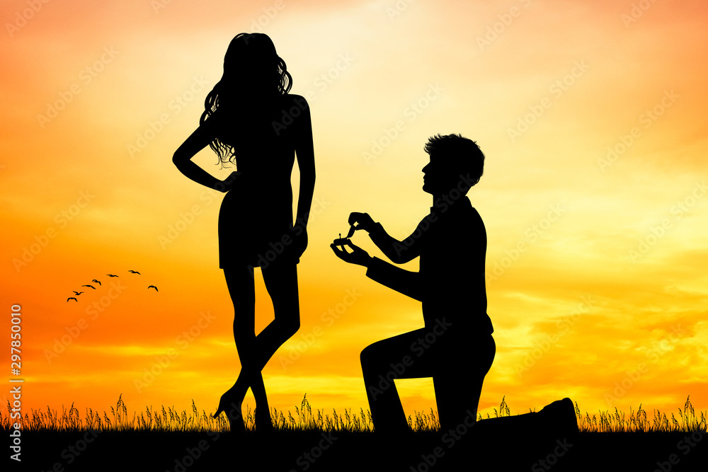 man propose to woman at sunset