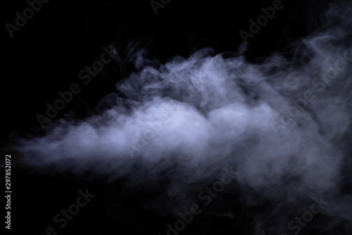 Jet of smoke on black background. Selective focus