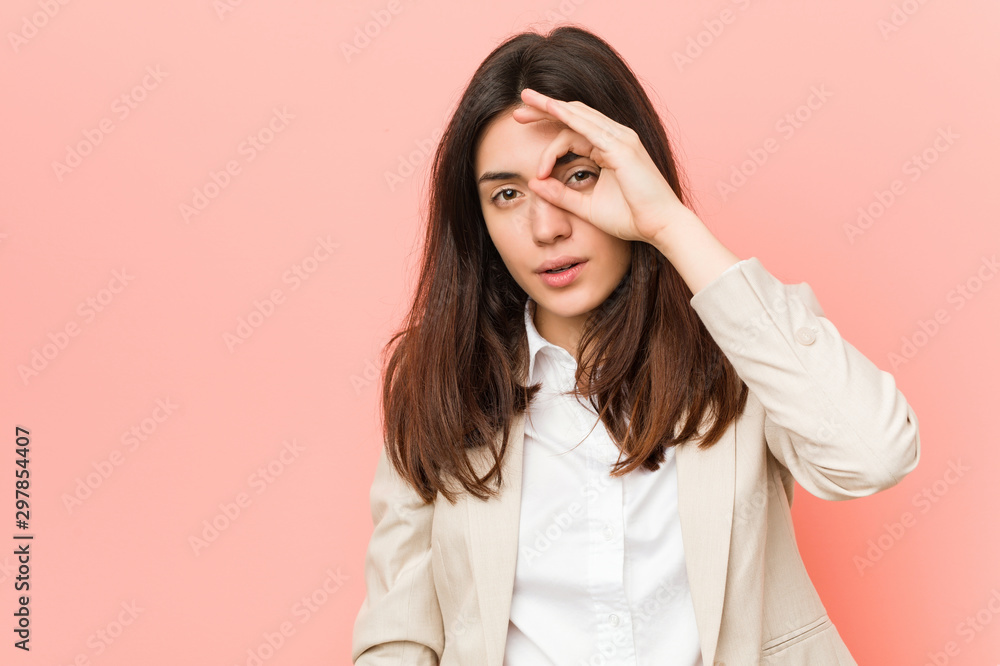 Young brunette business woman against a pink background excited keeping ok gesture on eye. Young brunette business woman against a pink background excited keeping ok gesture on eye.