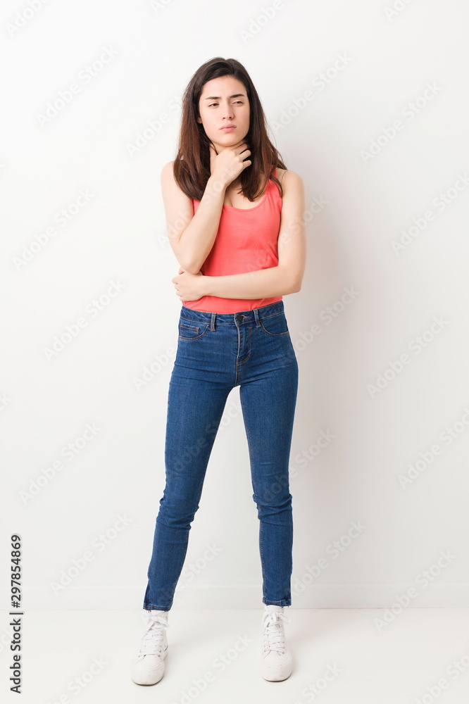 Full body young woman on white background suffers pain in throat due a virus or infection. Full body young woman on white background suffers pain in throat due a virus or infection.