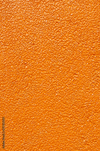 Surface of orange concrete mixed with gravel wall