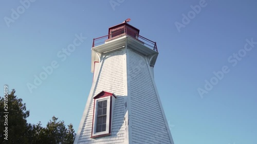 Wallpaper Mural Small lighthouse bathed in evening sunlight. Low angle orbital shot, looking up. Torontodigital.ca