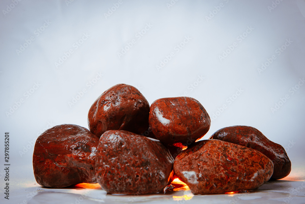 red smooth stones on a white background