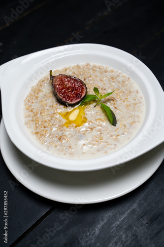 Milk Hercules porridge on a wooden table. 