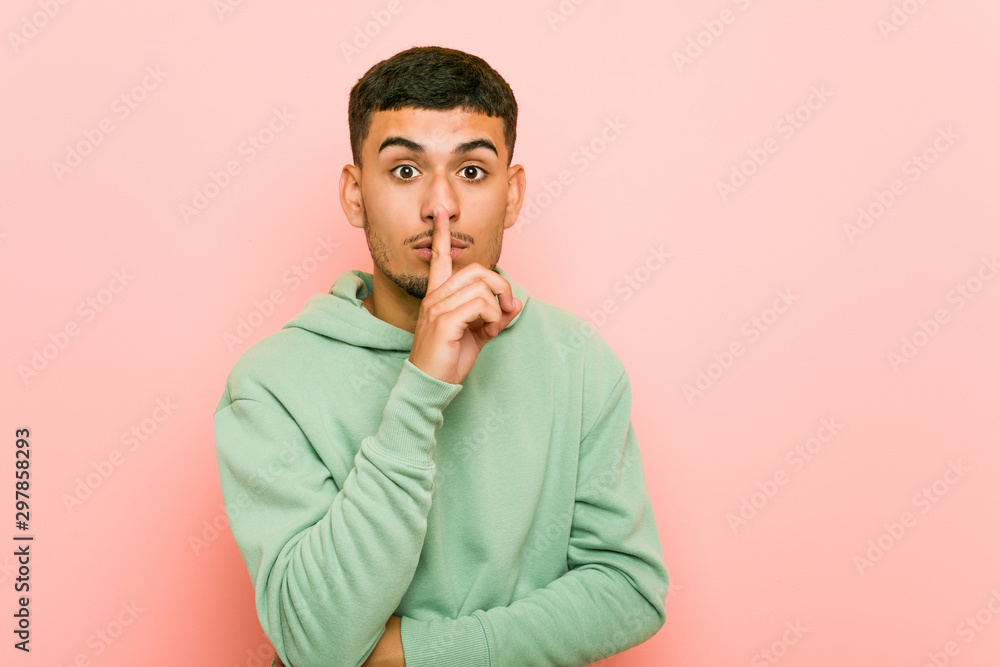 Young hispanic sport man keeping a secret or asking for silence. Young hispanic sport man keeping a secret or asking for silence.