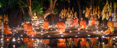 Canvas Print CHIANG MAI, THAILAND - May 18:  Visakha Puja Day Thai monks sitting meditate with many candle at Phan Tao temple  on May 18, 2019 in Chiang Mai, Thailand
