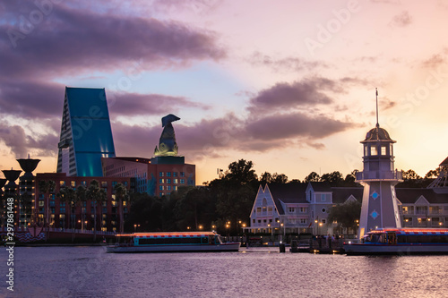 Orlando, Florida. October 11, 2019. Taxi boats , colorful hotel and lighthouse on sunset background at Lake Buena Vista 53.