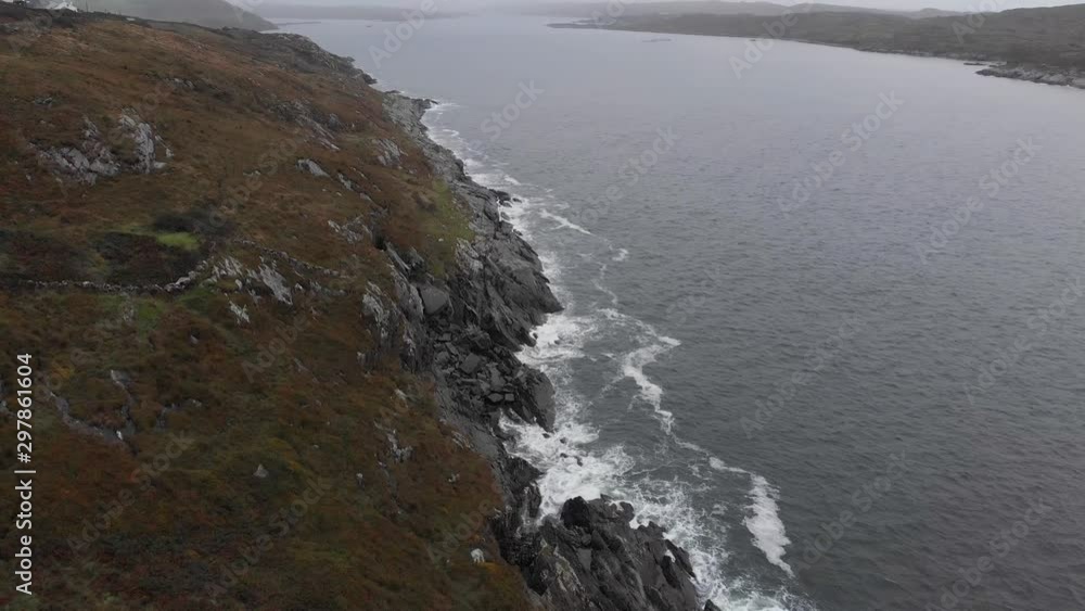 Aerial of moody irish landscape with cliffs of coastline on misty day Aerial of moody irish landscape with cliffs of coastline on misty day