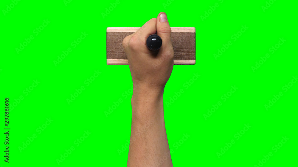Hand Holding Large Stamp on Chroma Key Green Background Hand Holding Large Stamp on Chroma Key Green Background