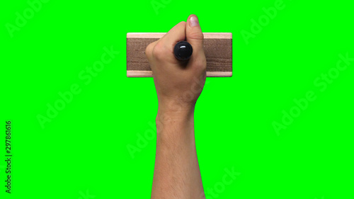 Hand Holding Large Stamp on Chroma Key Green Background	 photo