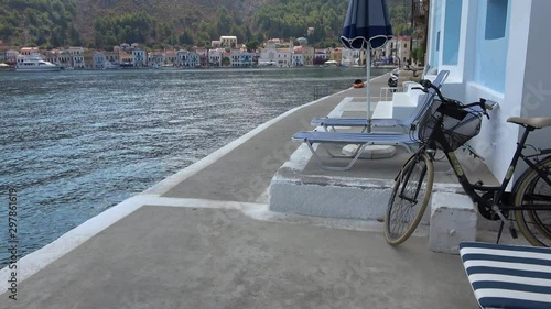 Castellorizo island, Greece - 1st of October 2019: 4K Bicycle and view on the Meyisti bay photo