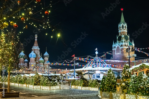 Moscow. Russia. Christmas Fair. Crassna Square in winter. St. Basil's Cathedral. Spasskaya tower at night. Illumination on the trees. Christmas trees in red square. New Year holidays in Russia photo